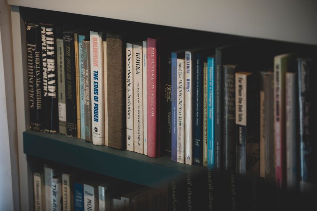 A close-up of a bookshelf filled with diverse books on various subjects, ideal for education and study.